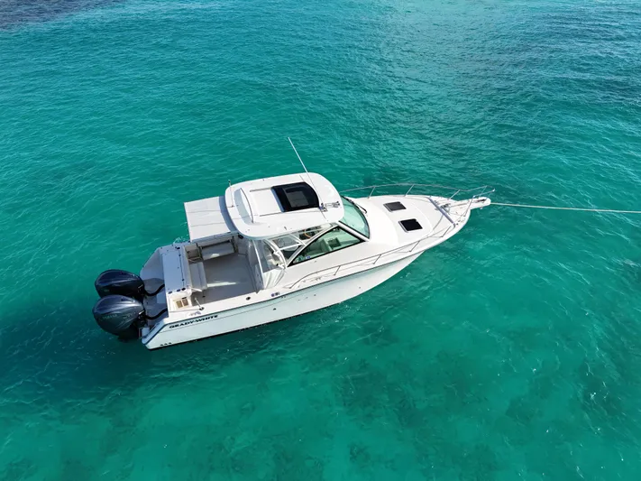  Yacht Photos Pics 2021 Grady-White Express 330 boat on clear turquoise water.