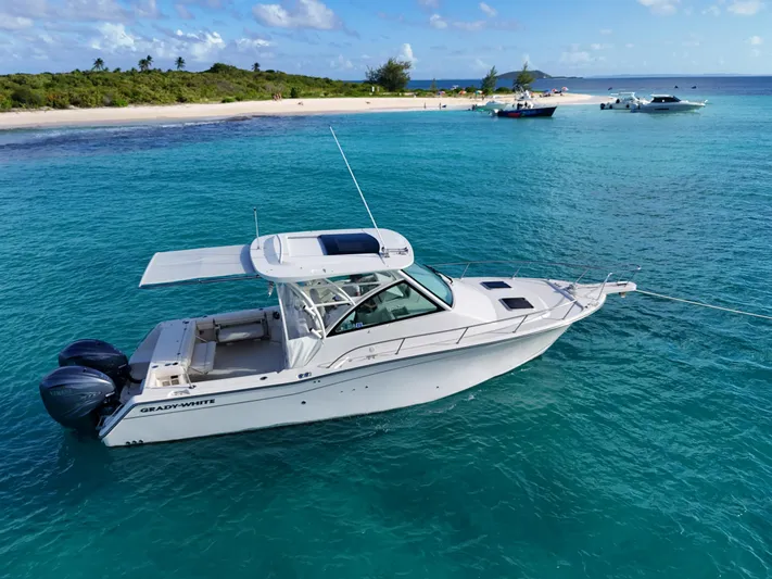  Yacht Photos Pics 2021 Grady-White Express 330 boat anchored near tropical beach, clear blue water.