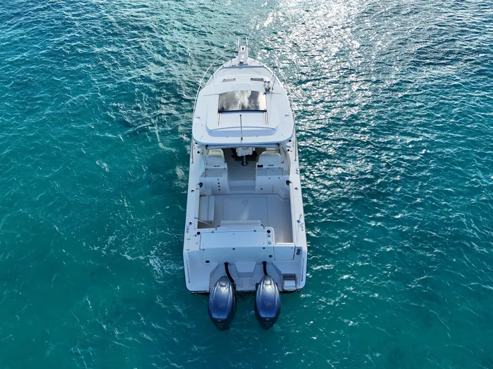  Yacht Photos Pics 2021 Grady-White Express 330 boat on clear blue water, aerial view.