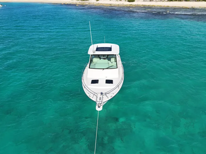  Yacht Photos Pics Grady-White Express 330 boat anchored in clear turquoise water, 2021 model.