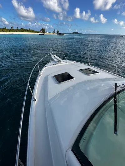  Yacht Photos Pics 2021 Grady-White Express 330 boat cruising near tropical island with clear blue skies.