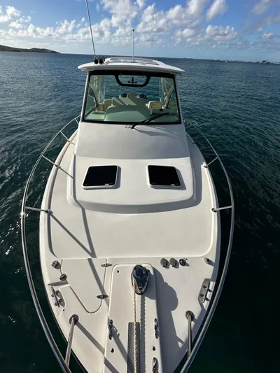  Yacht Photos Pics 2021 Grady-White Express 330 boat on calm ocean waters under a blue sky.