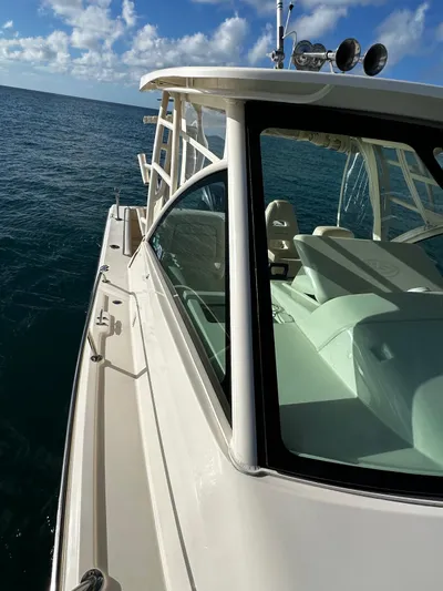  Yacht Photos Pics 2021 Grady-White Express 330 boat on open sea under blue sky.