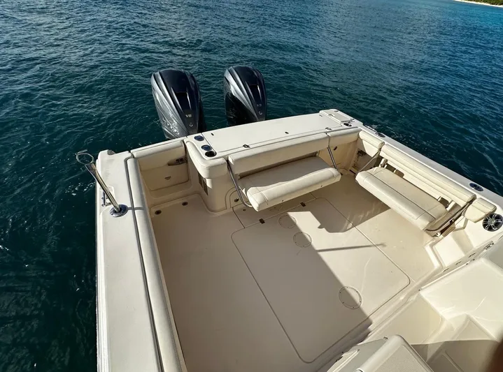  Yacht Photos Pics 2021 Grady-White Express 330 boat deck with twin engines on calm water.