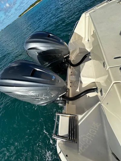  Yacht Photos Pics 2021 Grady-White Express 330 boat with dual outboard motors on clear water.