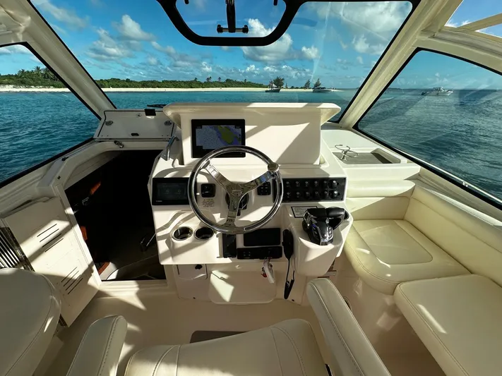  Yacht Photos Pics 2021 Grady-White Express 330 helm with ocean view and modern navigation equipment.