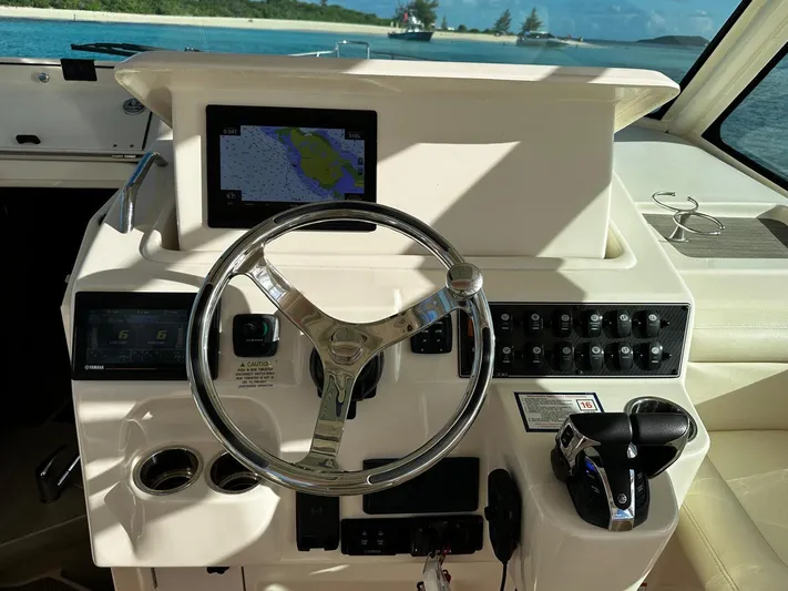  Yacht Photos Pics 2021 Grady-White Express 330 helm with steering wheel and navigation controls.