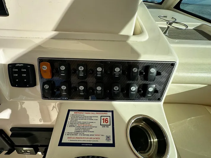  Yacht Photos Pics Control panel of 2021 Grady-White Express 330 boat with switches and cup holder.