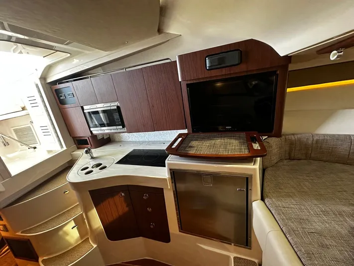  Yacht Photos Pics 2021 Grady-White Express 330 cabin interior with kitchenette and seating area.