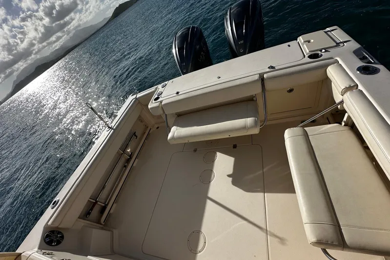  Yacht Photos Pics 2021 Grady-White Express 330 boat deck with dual engines on sunny ocean.