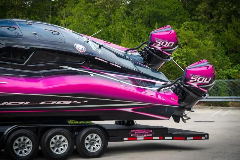  Yacht Photos Pics 2023 MTI 390XR boat with vibrant pink and black design on a trailer.