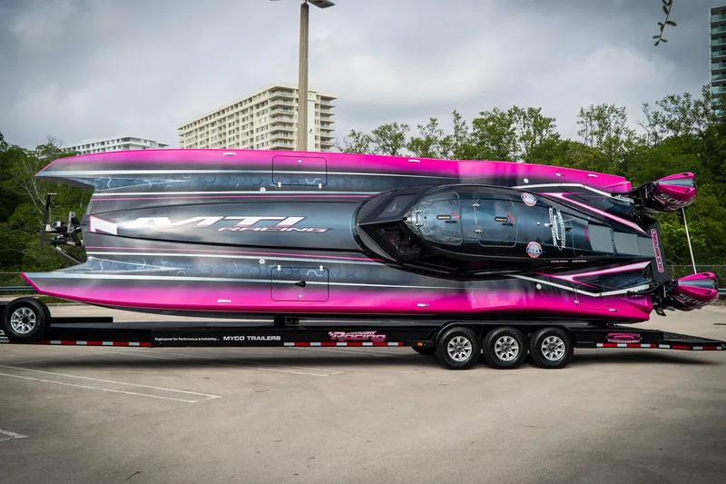  Yacht Photos Pics 2023 MTI 390XR powerboat with vibrant pink and black design on a trailer.