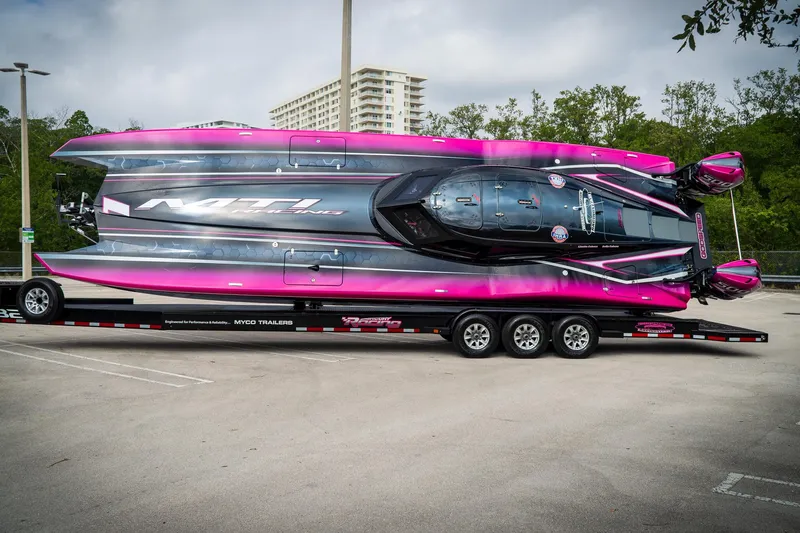  Yacht Photos Pics 2023 MTI 390XR powerboat with vibrant pink and black design on a trailer.