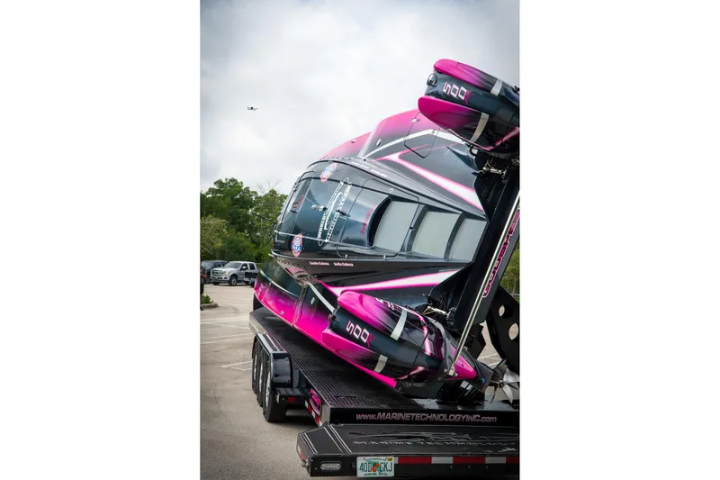  Yacht Photos Pics 2023 MTI 390XR powerboat with vibrant pink and black design on a trailer.