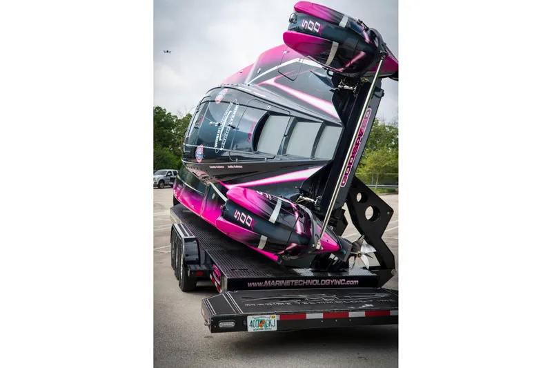  Yacht Photos Pics 2023 MTI 390XR powerboat in vibrant pink and black on a trailer.