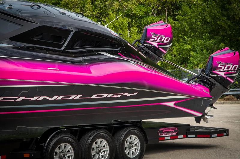  Yacht Photos Pics 2023 MTI 390XR powerboat with vibrant pink and black design on a trailer.