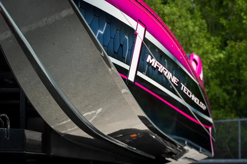  Yacht Photos Pics 2023 MTI 390XR boat with vibrant pink and black design, showcasing "Marine Technology" branding.