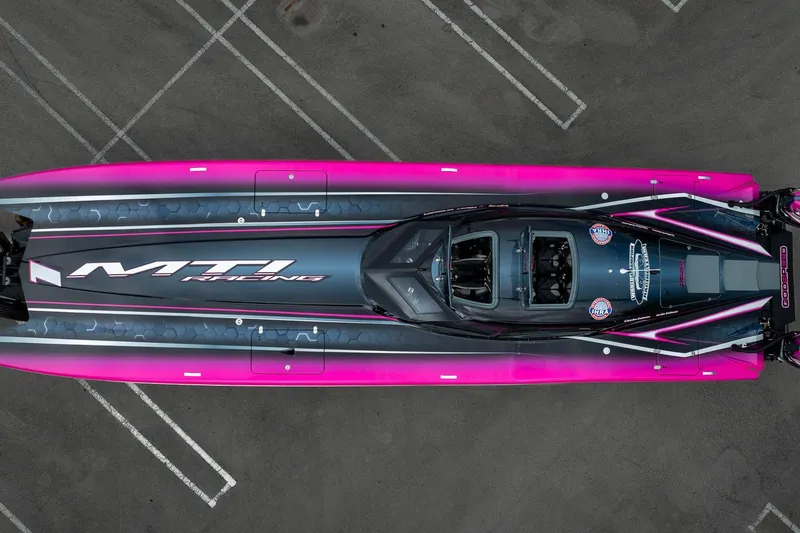  Yacht Photos Pics Aerial view of 2023 MTI 390XR racing boat with vibrant pink accents.