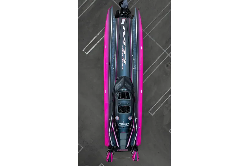  Yacht Photos Pics Aerial view of 2023 MTI 390XR powerboat with vibrant pink and gray design.
