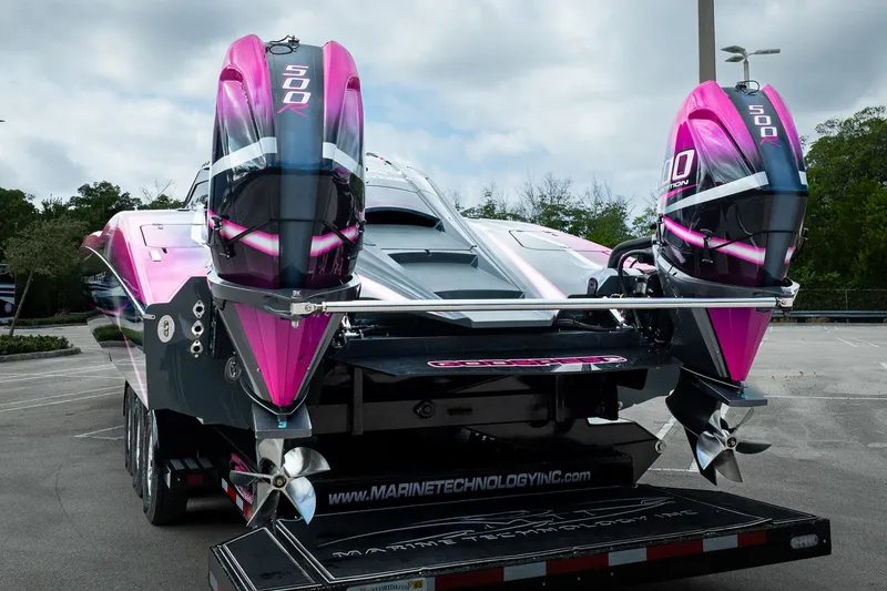  Yacht Photos Pics 2023 MTI 390XR powerboat with dual 500R engines, vibrant pink and black design.