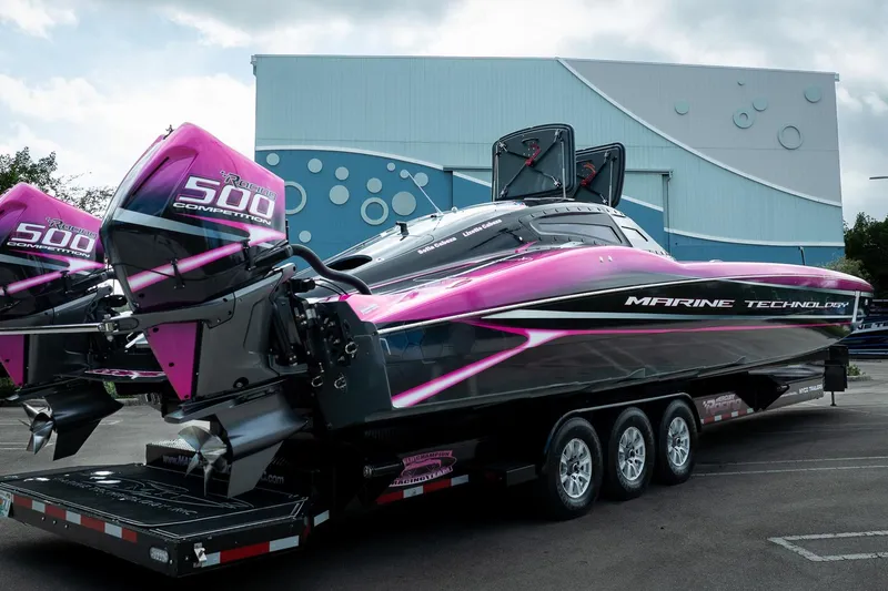  Yacht Photos Pics 2023 MTI 390XR powerboat with vibrant pink and black design, featuring dual 500 competition engines.