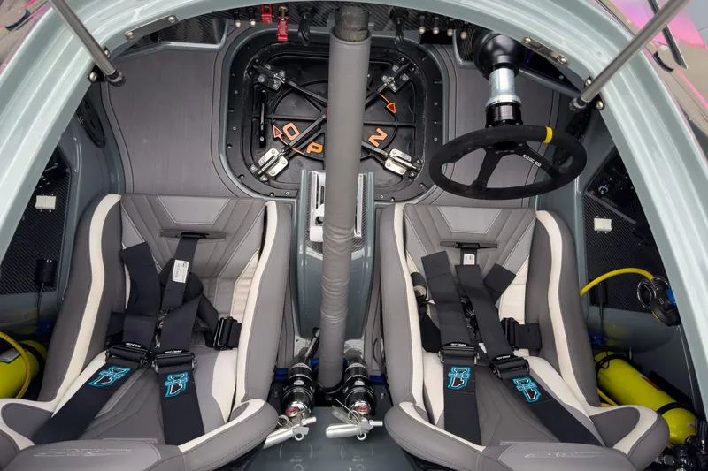  Yacht Photos Pics Interior of 2023 MTI 390XR boat with dual racing seats and steering wheel.