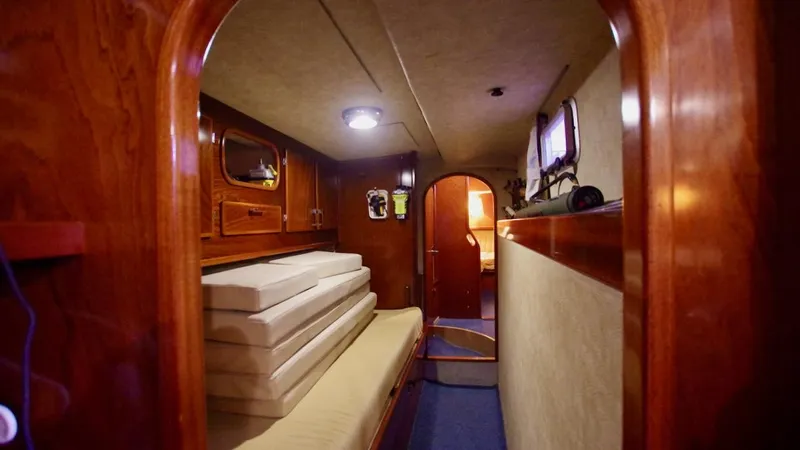 Forever Young Yacht Photos Pics Interior of 2000 Amel Super Maramu yacht with wooden finish and cozy seating area.