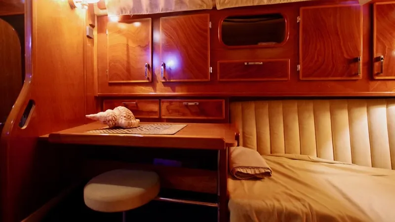 Forever Young Yacht Photos Pics Cozy cabin interior of 2000 Amel Super Maramu yacht with wooden furnishings and seating.