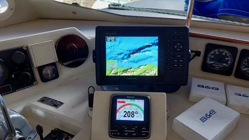Forever Young Yacht Photos Pics Navigation equipment on Amel Super Maramu 2000 yacht, featuring GPS and compass displays.