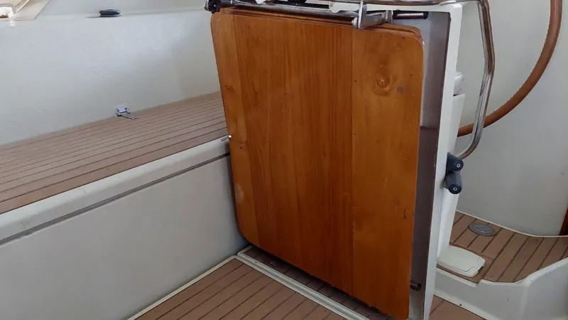 Forever Young Yacht Photos Pics Wooden hatch on Amel Super Maramu 2000 sailboat, showcasing teak deck and cockpit area.
