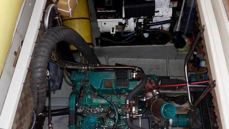 Forever Young Yacht Photos Pics Engine room of a 2000 Amel Super Maramu 2000 sailboat, featuring a well-maintained engine.