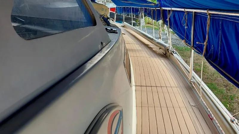 Forever Young Yacht Photos Pics Amel Super Maramu 2000 yacht deck with blue tarps and wooden flooring.