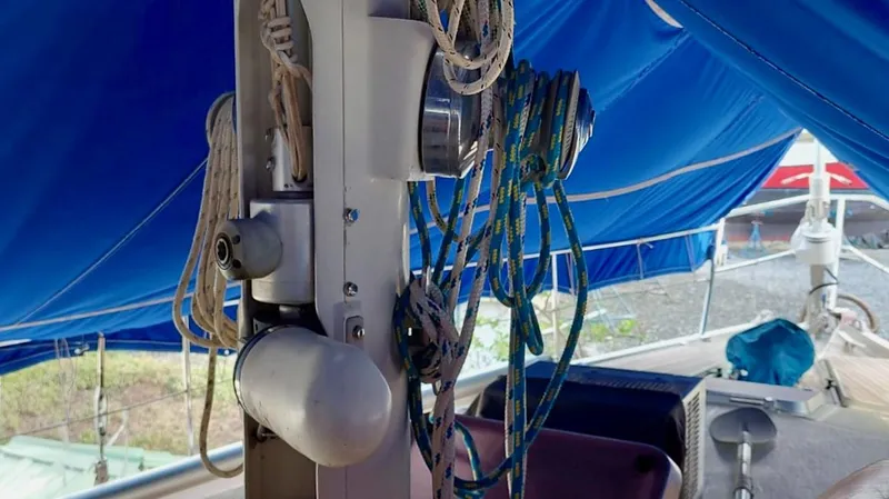 Forever Young Yacht Photos Pics Sailboat rigging on a 2000 Amel Super Maramu, under a blue canopy.