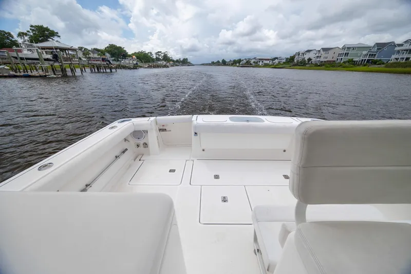 Knot On Call Yacht Photos Pics 2004 Tiara Yachts 3200 Open cruising on a scenic river with waterfront homes.