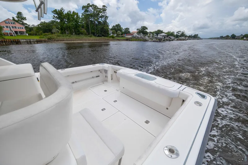 Knot On Call Yacht Photos Pics 2004 Tiara Yachts 3200 Open cruising on a scenic river with lush greenery.