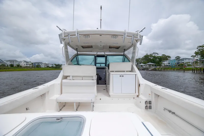 Knot On Call Yacht Photos Pics 2004 Tiara Yachts 3200 Open boat on water, featuring spacious deck and seating.