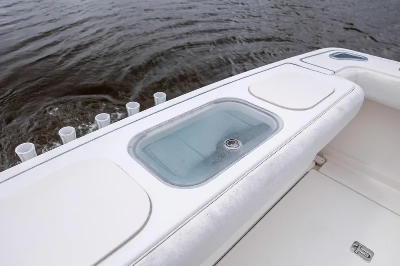 Knot On Call Yacht Photos Pics 2004 Tiara Yachts 3200 Open boat deck with storage compartments and rod holders.