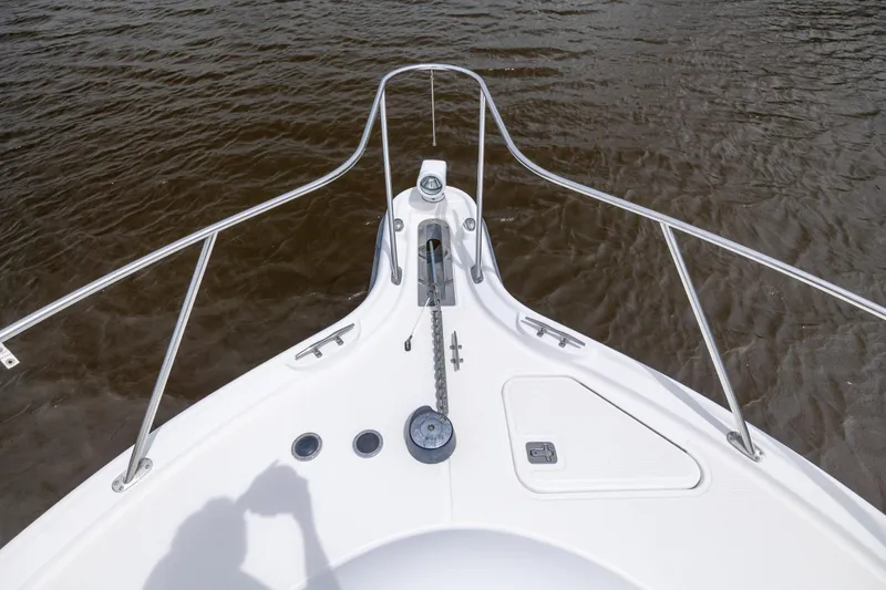 Knot On Call Yacht Photos Pics Bow of 2004 Tiara Yachts 3200 Open on water, featuring anchor and railing.