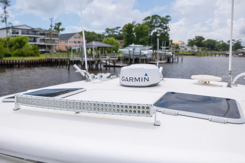 Knot On Call Yacht Photos Pics 2004 Tiara Yachts 3200 Open with Garmin equipment on deck, docked by waterfront homes.