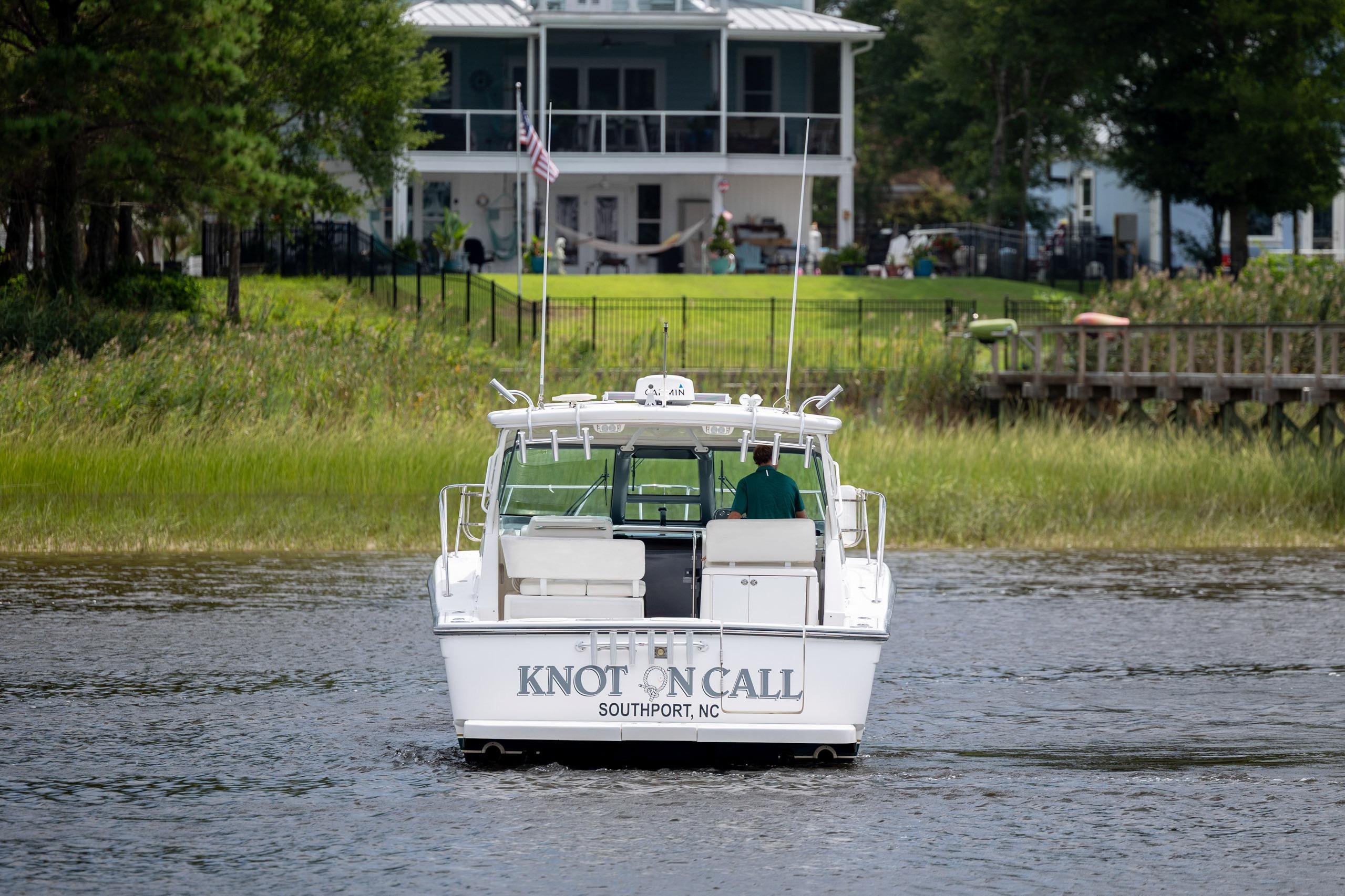 2004 Tiara Yachts 3200 Open boat named "Knot on Call" on a serene waterway.