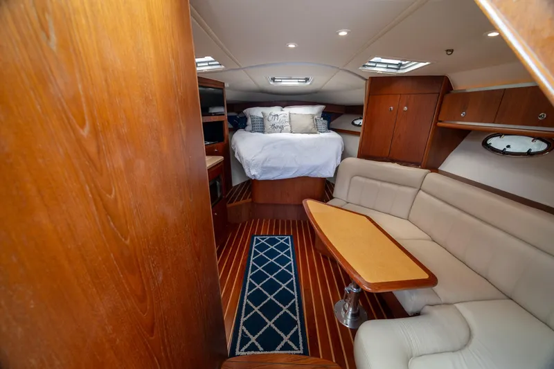 Knot On Call Yacht Photos Pics Luxurious 2004 Tiara Yachts 3200 Open interior with cozy bed and elegant seating area.