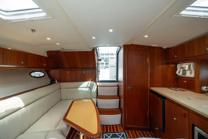 Knot On Call Yacht Photos Pics 2004 Tiara Yachts 3200 Open interior with wood finish and cozy seating area.