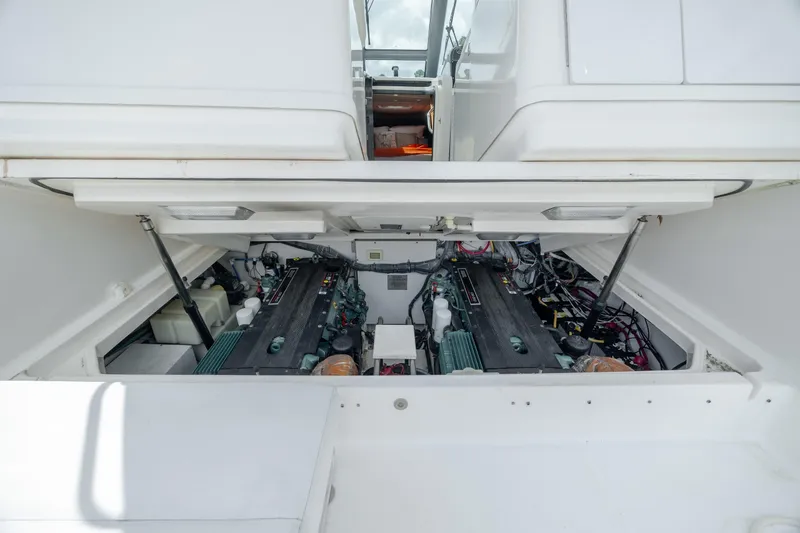 Knot On Call Yacht Photos Pics Engine compartment of 2004 Tiara Yachts 3200 Open, showcasing dual engines and mechanical components.