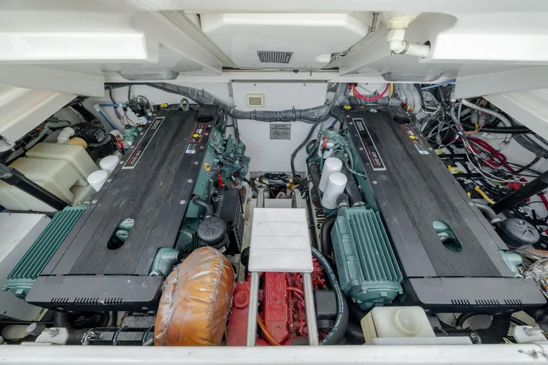 Knot On Call Yacht Photos Pics Engine room of 2004 Tiara Yachts 3200 Open, showcasing dual engines and complex wiring.