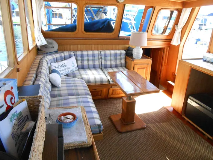  Yacht Photos Pics Cozy interior of 1983 Californian 42 yacht with plaid seating and wooden furnishings.
