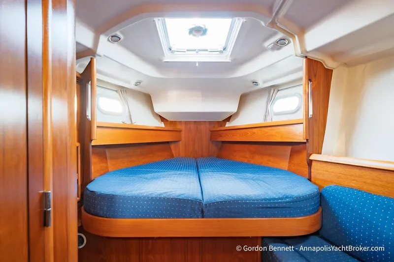 Margaritaville Yacht Photos Pics Cozy cabin interior of 2004 Jeanneau Sun Odyssey 43 DS yacht with blue bedding.