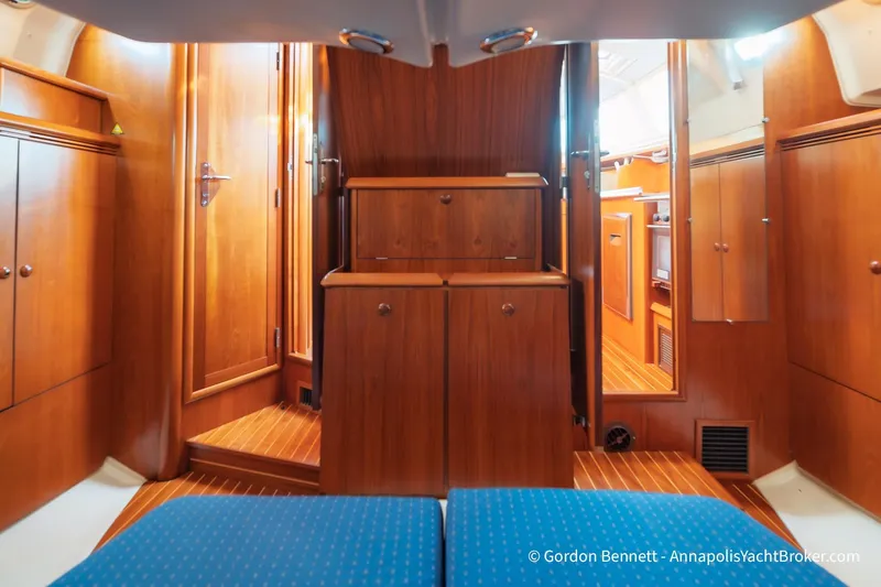 Margaritaville Yacht Photos Pics Interior of 2004 Jeanneau Sun Odyssey 43 DS yacht with wooden cabinetry and blue seating.