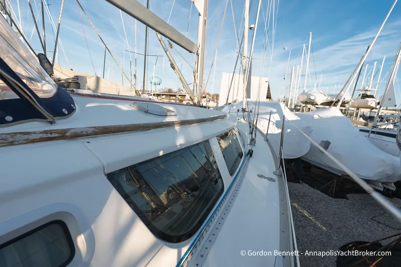Margaritaville Yacht Photos Pics 2004 Jeanneau Sun Odyssey 43 DS sailboat in marina, side view with clear sky.