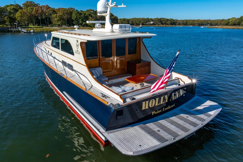 Holly Ann Yacht Photos Pics 2010 Vicem 64 Classic yacht on serene water, featuring elegant design and American flag.