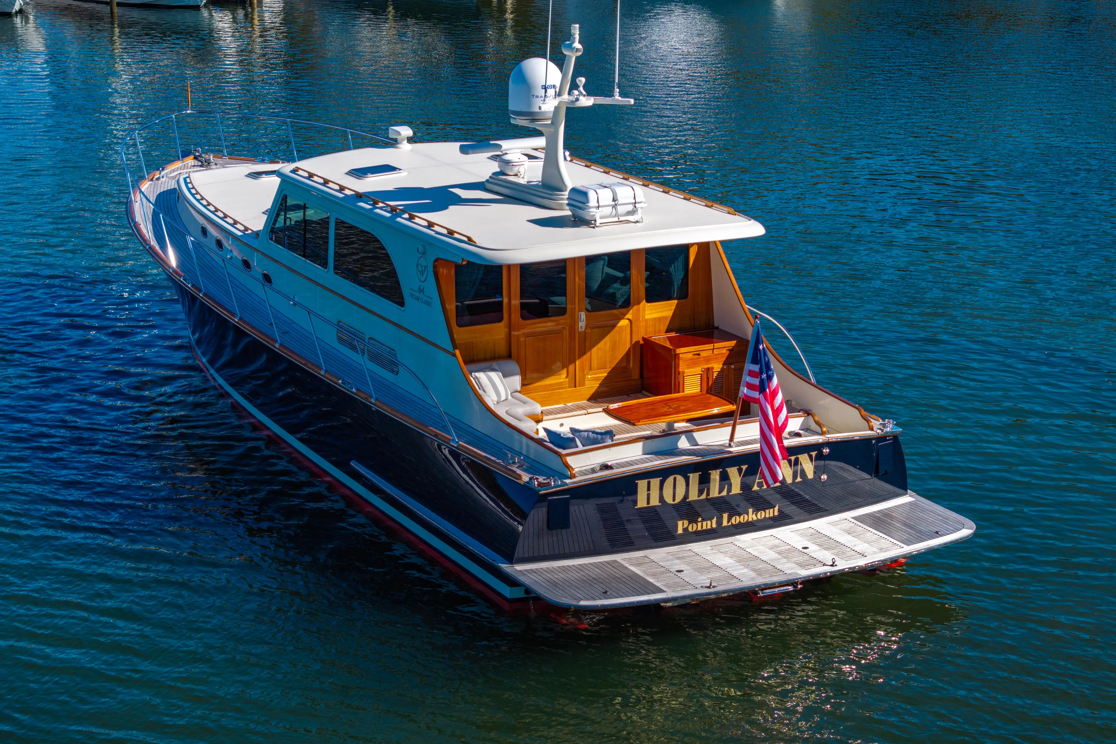 Holly Ann Yacht Photos Pics 2010 Vicem 64 Classic yacht on water, rear view with American flag.